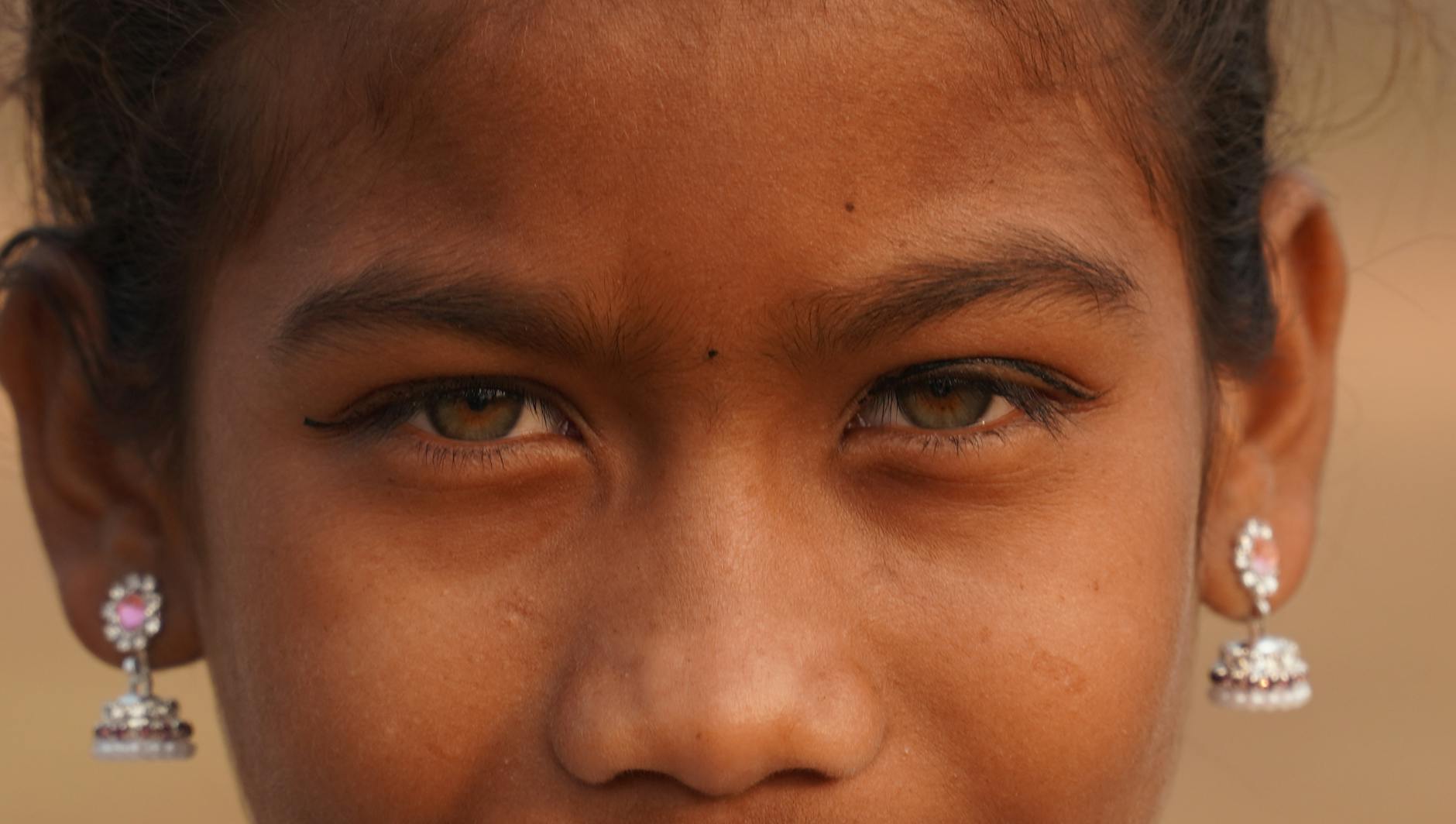 A close-up portrait of a South Asian girl wearing earrings in Jamshedpur, India.
