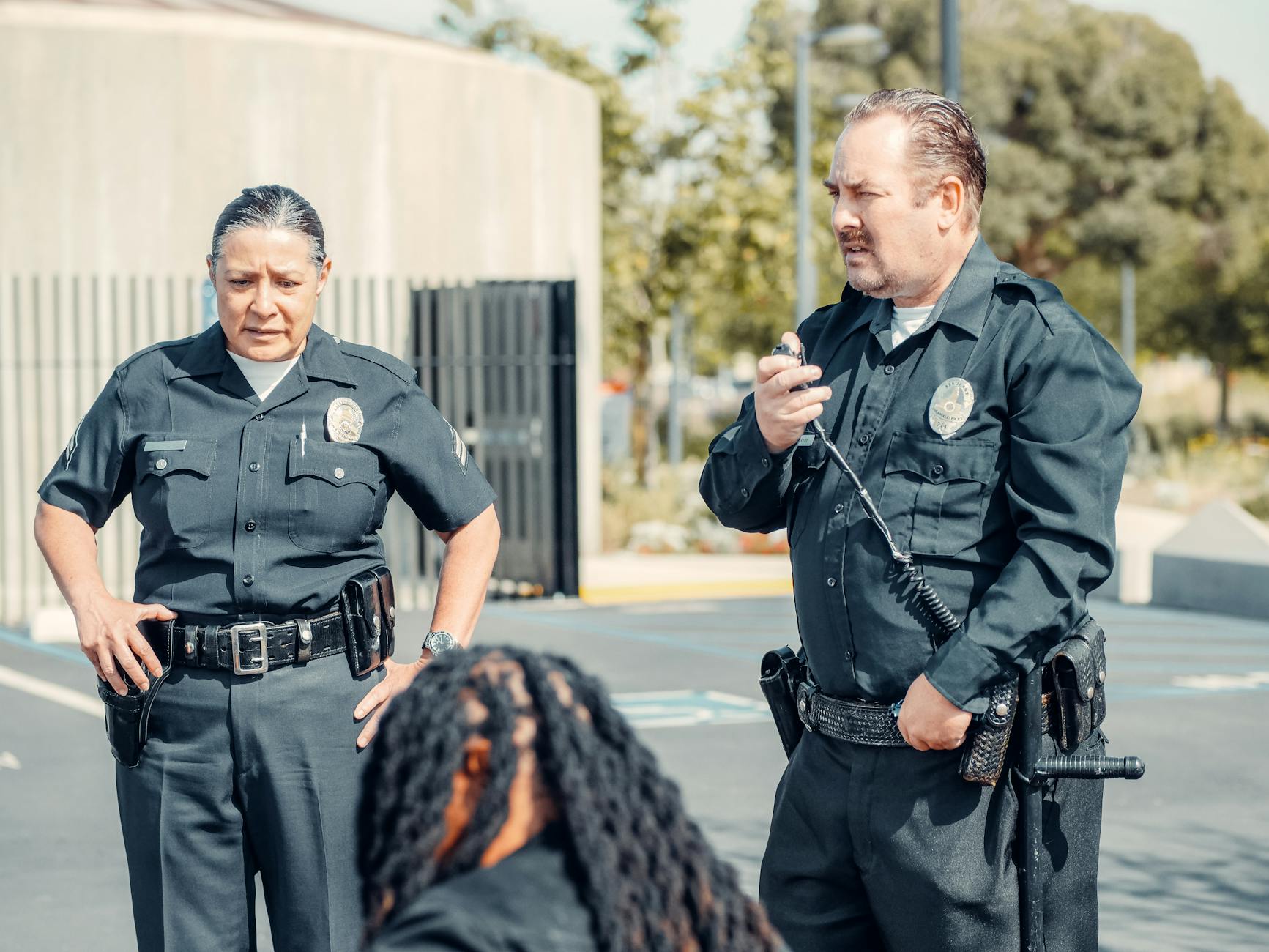 Two police officers interacting at a crime scene, focusing on communication and law enforcement duties.