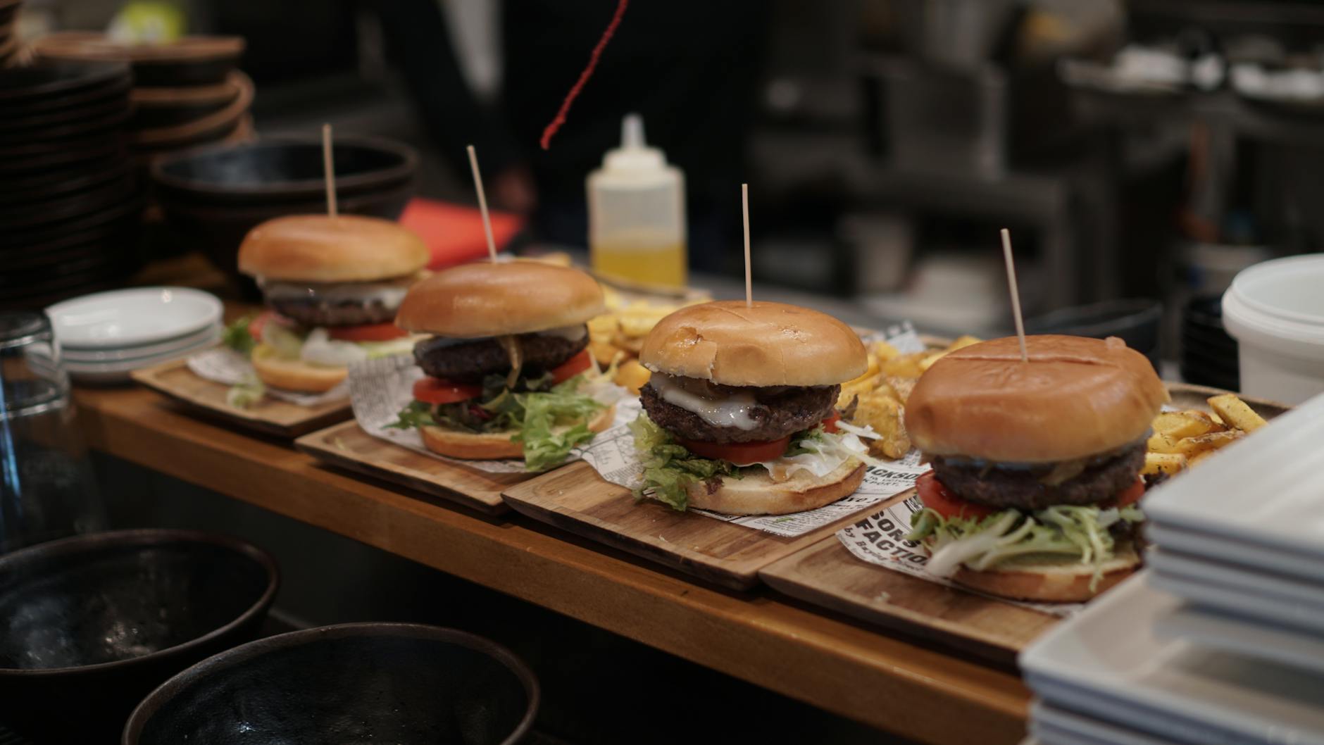 Gourmet burgers with fresh toppings beautifully presented in a row, ideal for fast food lovers.
